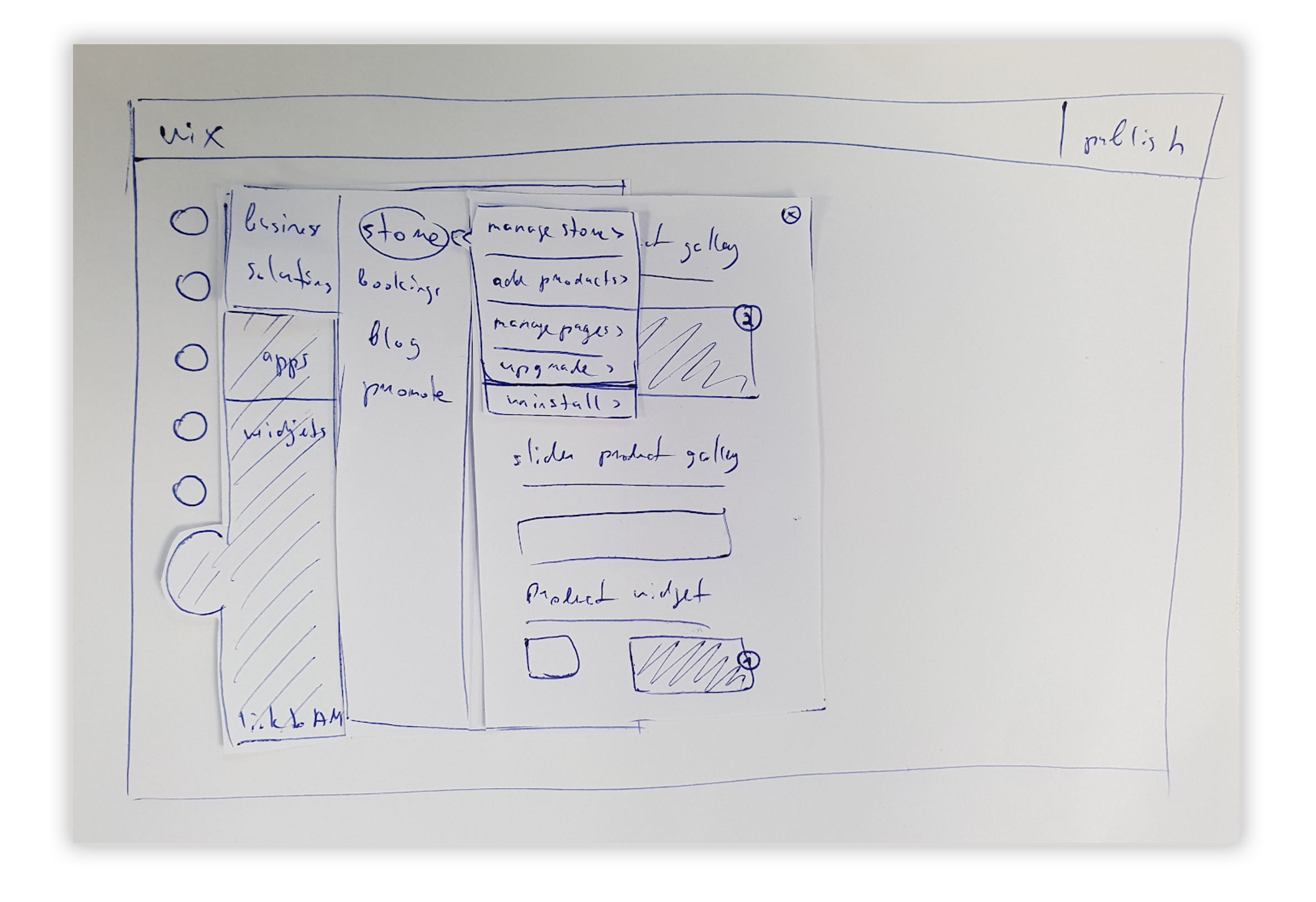 Paper prototypes of app behaviors laid out on a desk